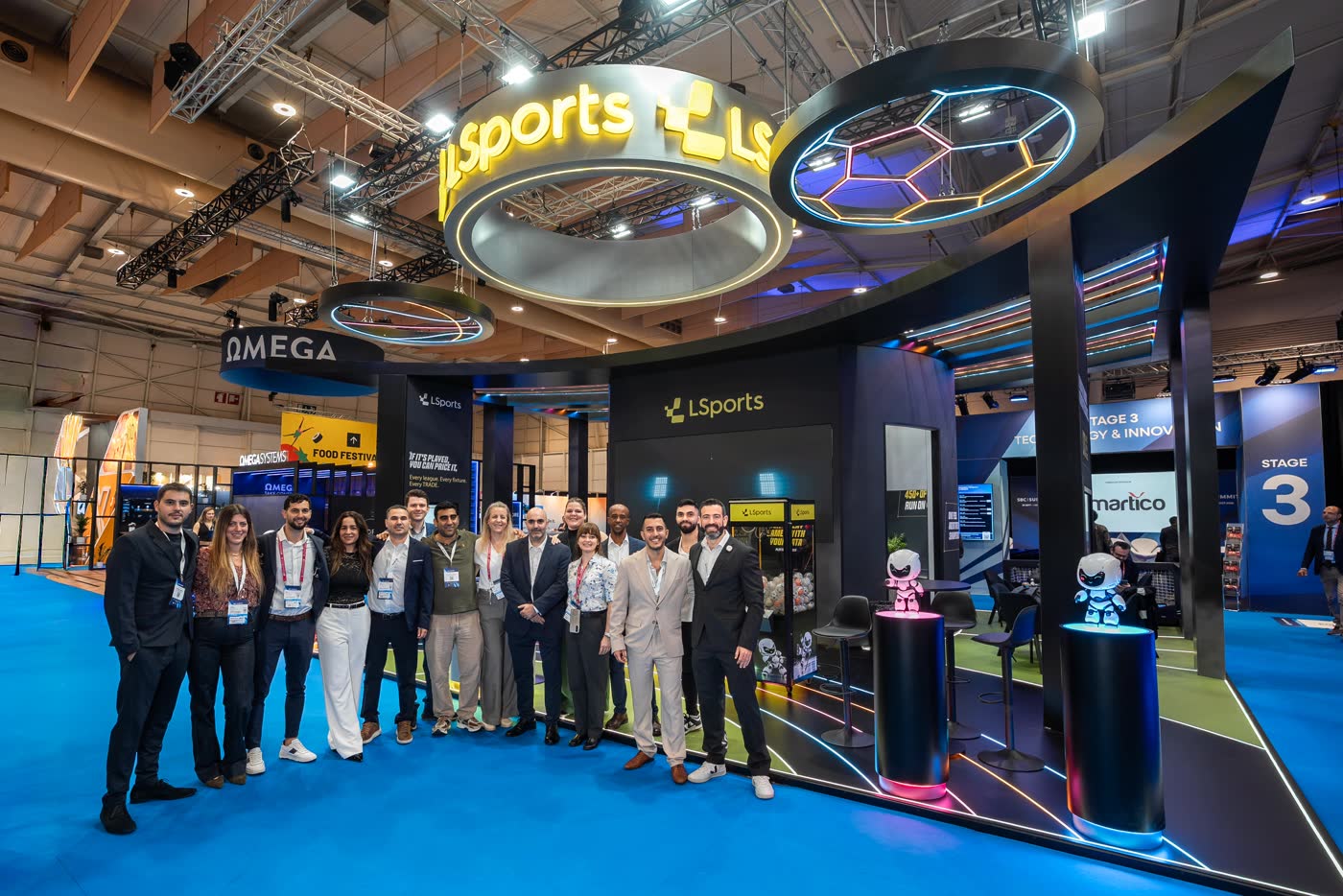 LSports team in front of the company banner at SBC Summit Lisbon